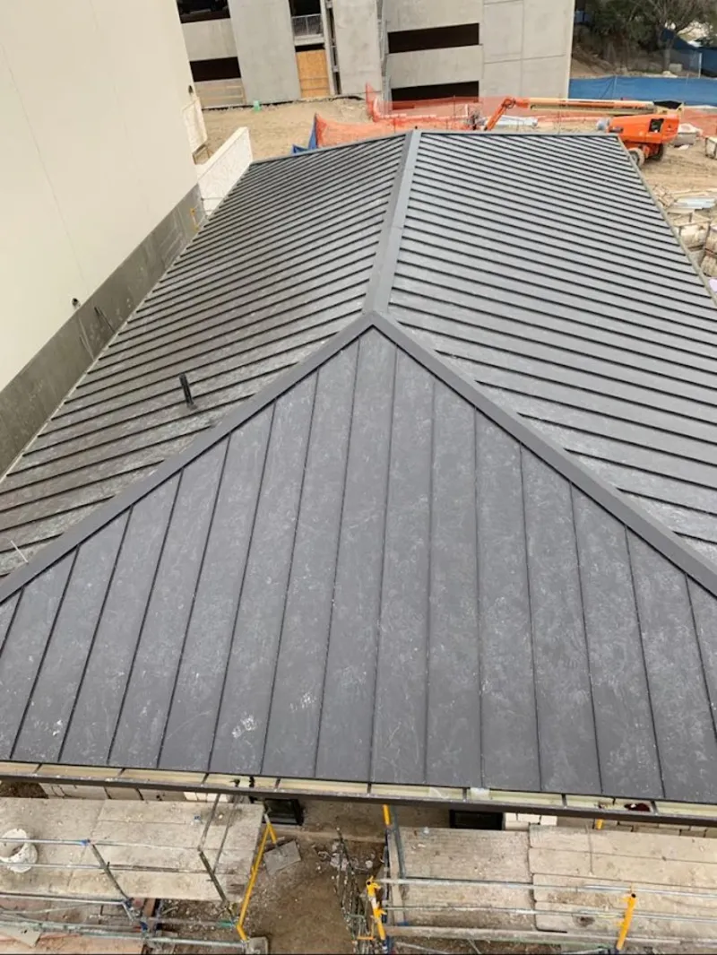 Commercial metal roof construction with crane equipment in Zeeland